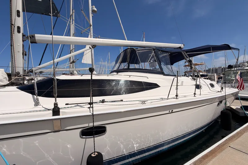 Slide: The Image of 2009 Hunter 50 Center Cockpit sailboat docked at marina under clear blue sky. - 6