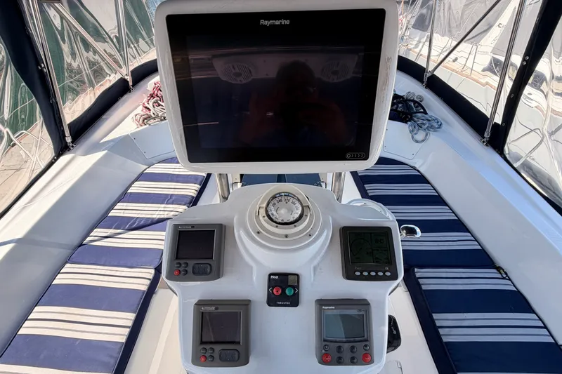 Slide: The Image of Cockpit of 2009 Hunter 50 Center Cockpit sailboat with navigation instruments and striped seating. - 31