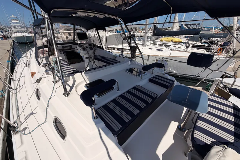 Slide: The Image of 2009 Hunter 50 Center Cockpit sailboat with striped seating, docked at a marina. - 17