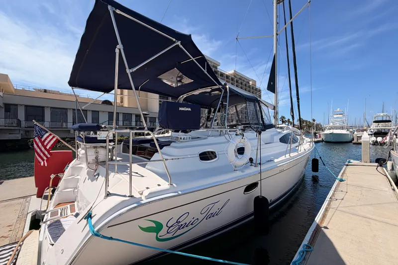 Slide: The Image of 2009 Hunter 50 Center Cockpit sailboat docked at marina with blue canopy. - 10