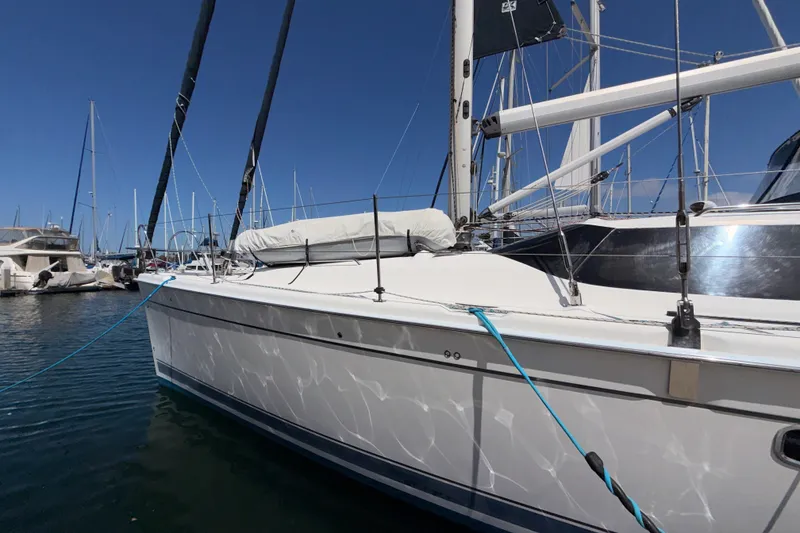 Slide: The Image of 2009 Hunter 50 Center Cockpit sailboat docked in marina under clear blue sky. - 5