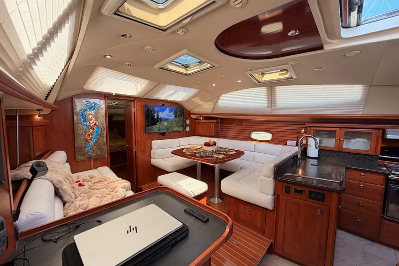 Slide: The Image of Luxurious interior of a 2009 Hunter 50 Center Cockpit yacht with elegant wood finishes. - 50