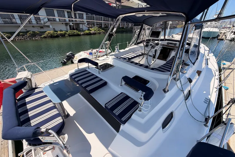 Slide: The Image of 2009 Hunter 50 Center Cockpit sailboat with striped seating, docked in a marina. - 15