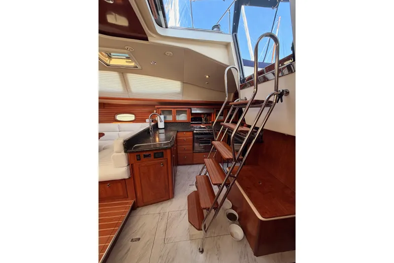 Slide: The Image of Luxurious interior of 2009 Hunter 50 Center Cockpit yacht with wooden cabinetry and modern amenities. - 51