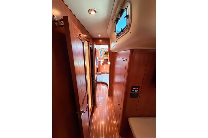 Slide: The Image of Interior hallway of 2009 Hunter 50 Center Cockpit yacht with wooden finishes. - 97