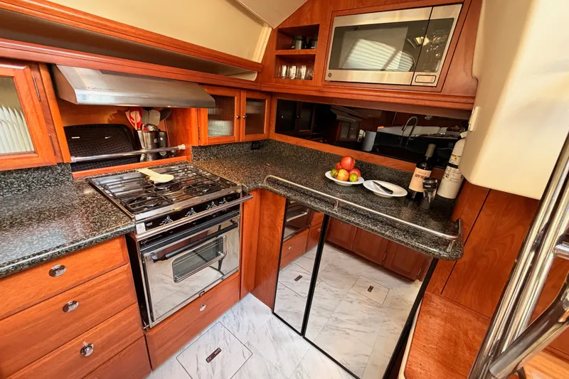 Slide: The Image of Luxurious 2009 Hunter 50 Center Cockpit yacht kitchen with modern appliances and wood cabinetry. - 52