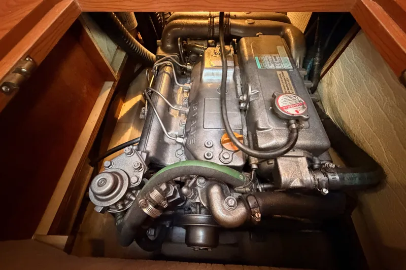Slide: The Image of Engine compartment of a 2009 Hunter 50 Center Cockpit sailboat, showcasing detailed machinery. - 101
