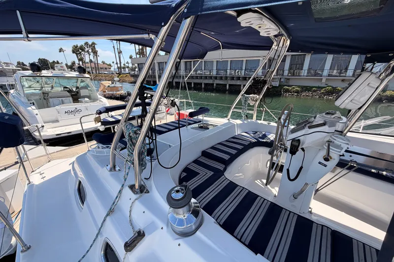 Slide: The Image of 2009 Hunter 50 Center Cockpit sailboat with striped seating, docked in a marina. - 27