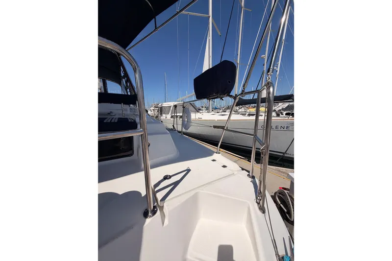 Slide: The Image of 2009 Hunter 50 Center Cockpit sailboat deck with stainless steel railings in marina. - 14