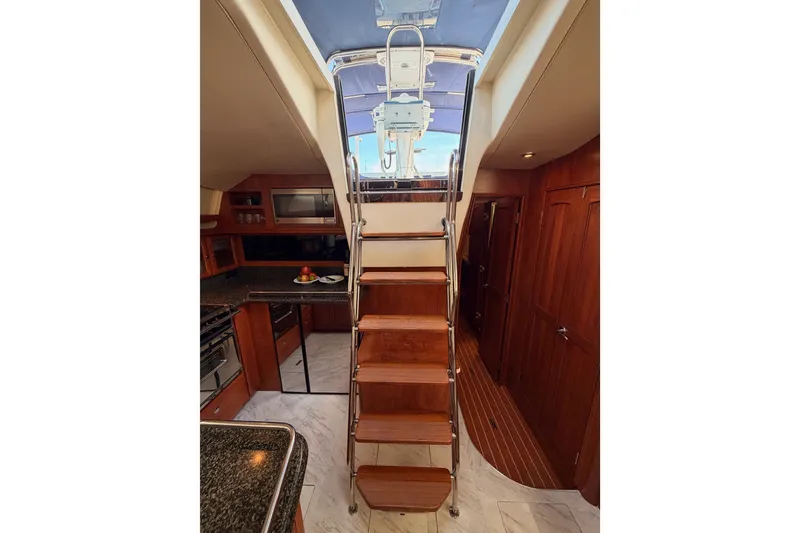 Slide: The Image of Interior of 2009 Hunter 50 Center Cockpit yacht with wooden stairs and modern kitchen. - 100