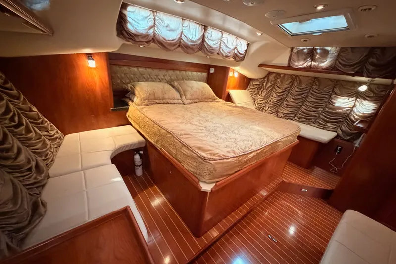 Slide: The Image of Luxurious 2009 Hunter 50 Center Cockpit yacht interior with elegant wood finish and plush bedding. - 95
