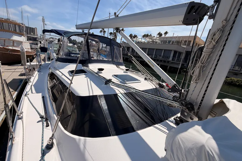 Slide: The Image of 2009 Hunter 50 Center Cockpit sailboat docked at a marina, showcasing sleek design. - 25