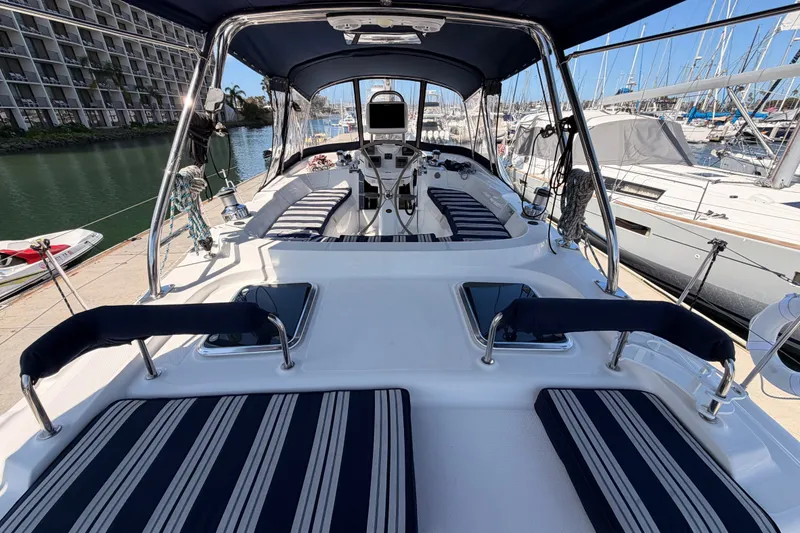Slide: The Image of 2009 Hunter 50 Center Cockpit sailboat with striped seating, docked at a marina. - 28