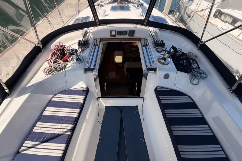 Slide: The Image of 2009 Hunter 50 Center Cockpit sailboat interior with striped cushions and nautical equipment. - 35
