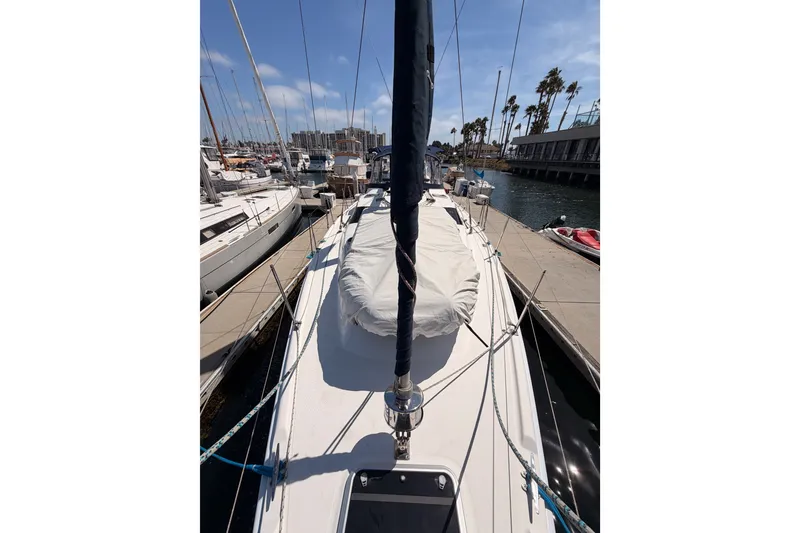 Slide: The Image of 2009 Hunter 50 Center Cockpit sailboat docked at marina, sunny day, palm trees in background. - 24
