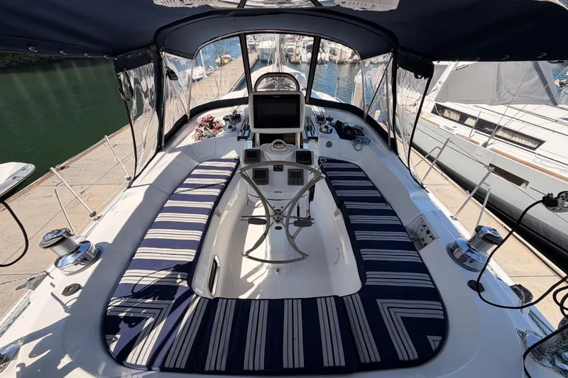 Slide: The Image of 2009 Hunter 50 Center Cockpit sailboat with striped seating and navigation equipment. - 29