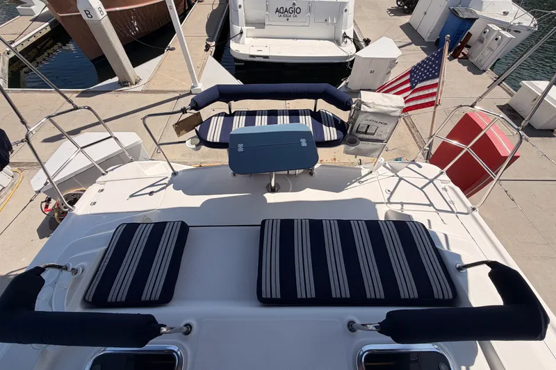 Slide: The Image of 2009 Hunter 50 Center Cockpit yacht with striped cushions and American flag at dock. - 16