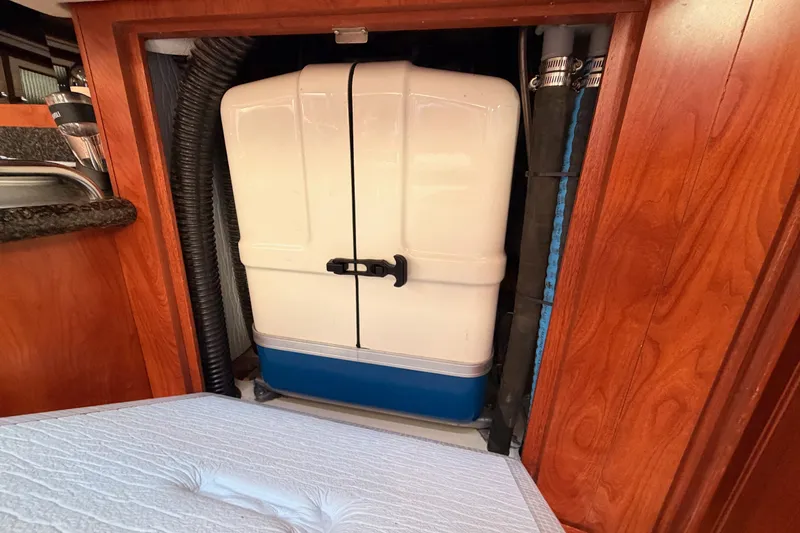 Slide: The Image of 2009 Hunter 50 Center Cockpit interior with storage compartment and plumbing. - 104