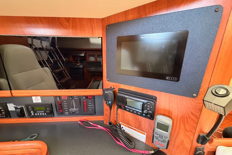 Slide: The Image of Interior of 2009 Hunter 50 Center Cockpit with navigation equipment and control panel. - 48