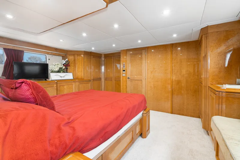 Slide: The Image of Luxurious bedroom interior of 1996 Hatteras 70 Sport Deck Motor Yacht with wood paneling. - 50