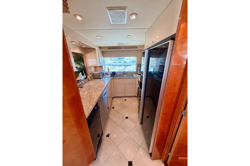 Slide: The Image of Luxurious kitchen interior of 1996 Hatteras 70 Sport Deck Motor Yacht with granite countertops. - 41