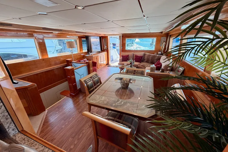 Slide: The Image of Luxurious interior of 1996 Hatteras 70 Sport Deck Motor Yacht with elegant seating and dining area. - 39