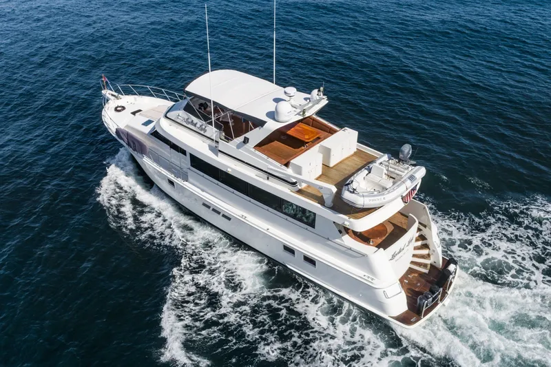 Slide: The Image of 1996 Hatteras 70 Sport Deck Motor Yacht cruising on open water. - 4
