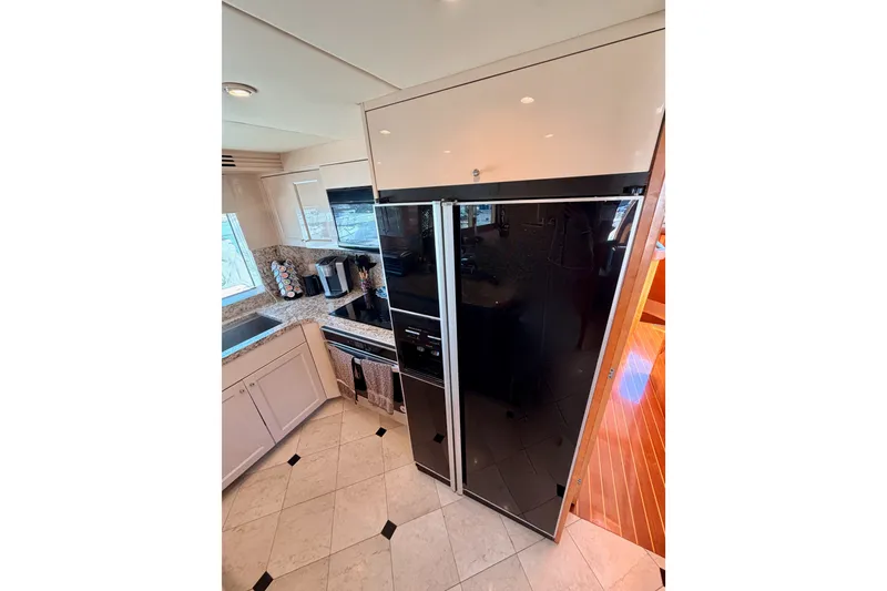Slide: The Image of Luxurious kitchen interior of 1996 Hatteras 70 Sport Deck Motor Yacht. - 44