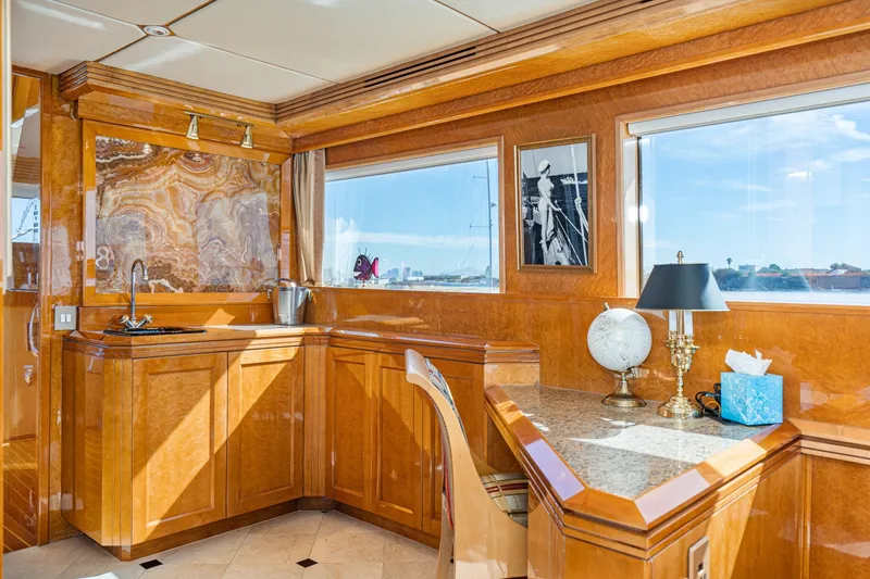 Slide: The Image of Luxurious interior of a 1996 Hatteras 70 Sport Deck Motor Yacht with elegant wood finishes. - 48