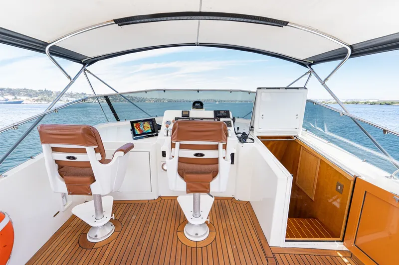 Slide: The Image of Flybridge of 1996 Hatteras 70 Sport Deck Motor Yacht with helm and seating. - 22