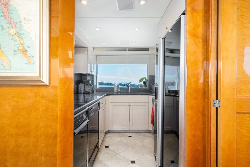 Slide: The Image of Luxurious kitchen interior of 1996 Hatteras 70 Sport Deck Motor Yacht with ocean view. - 39