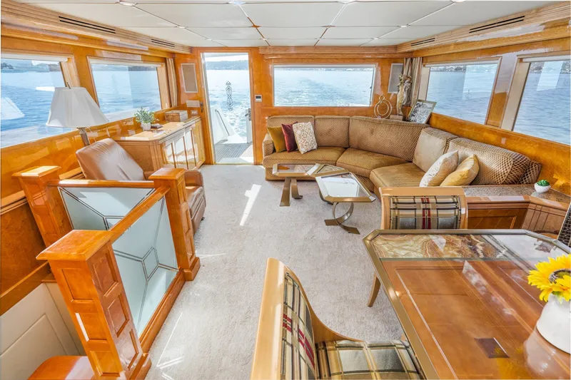 Slide: The Image of Luxurious interior of 1996 Hatteras 70 Sport Deck Motor Yacht with elegant furnishings and panoramic windows. - 36