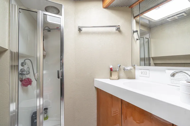 Slide: The Image of Bathroom interior of 1996 Hatteras 70 Sport Deck Motor Yacht with shower and vanity. - 63