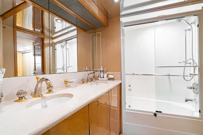 Slide: The Image of Luxurious bathroom in 1996 Hatteras 70 Sport Deck Motor Yacht with elegant fixtures and mirrored cabinetry. - 66