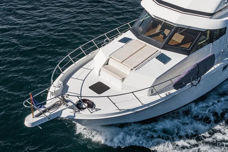 Slide: The Image of 1996 Hatteras 70 Sport Deck Motor Yacht cruising on open water. - 9