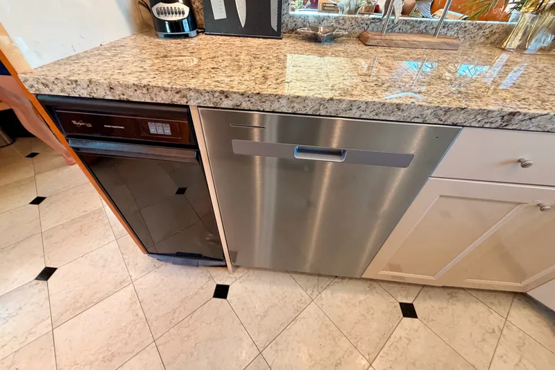 Slide: The Image of Kitchen area on 1996 Hatteras 70 Sport Deck Motor Yacht with granite countertop and appliances. - 48