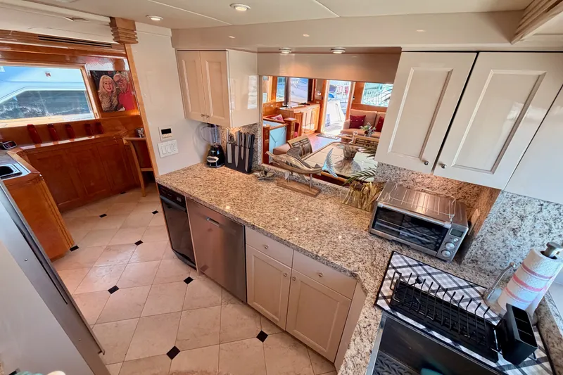 Slide: The Image of Luxurious kitchen interior of 1996 Hatteras 70 Sport Deck Motor Yacht with granite countertops. - 47