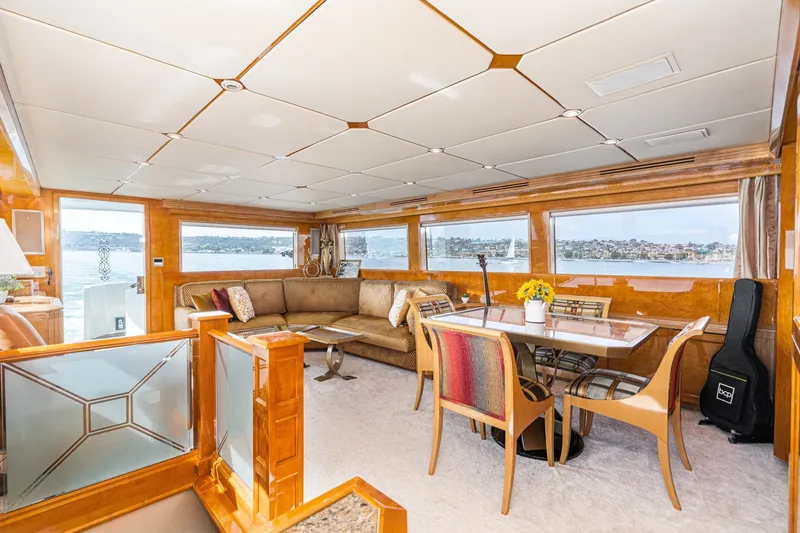 Slide: The Image of Luxurious interior of 1996 Hatteras 70 Sport Deck Motor Yacht with elegant seating and dining area. - 41
