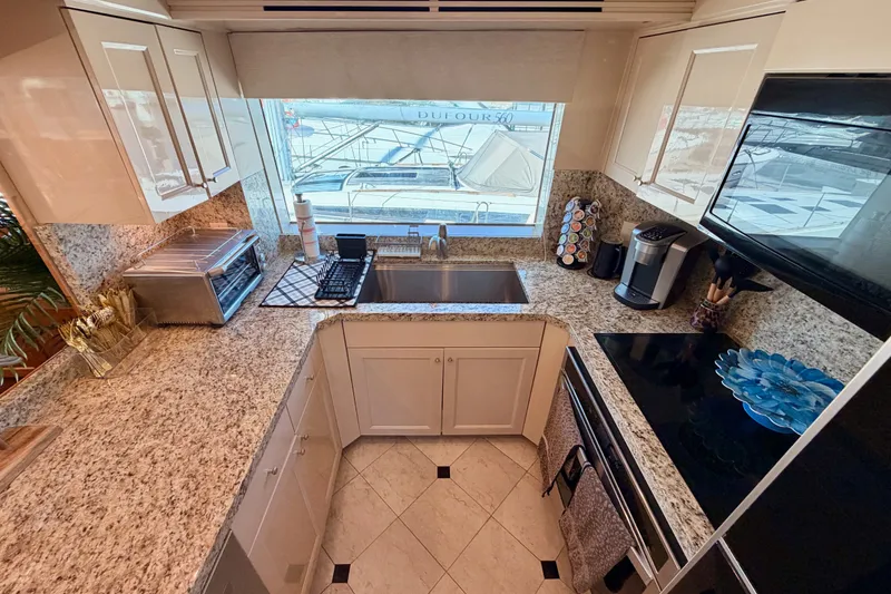 Slide: The Image of Modern kitchen in 1996 Hatteras 70 Sport Deck Motor Yacht with granite countertops and appliances. - 43