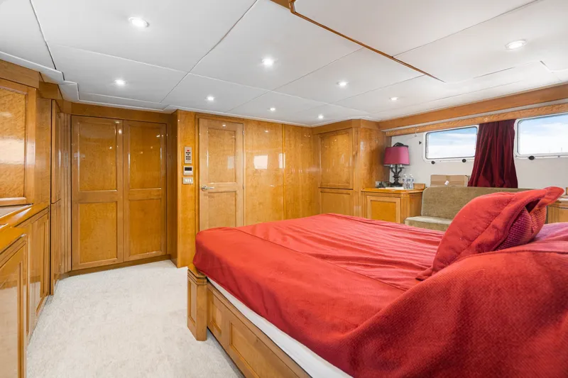 Slide: The Image of Luxurious bedroom interior of 1996 Hatteras 70 Sport Deck Motor Yacht with red bedding. - 49