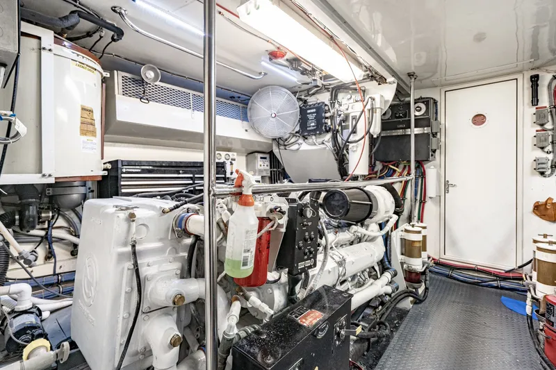 Slide: The Image of Engine room of 1996 Hatteras 70 Sport Deck Motor Yacht, showcasing machinery and equipment. - 70