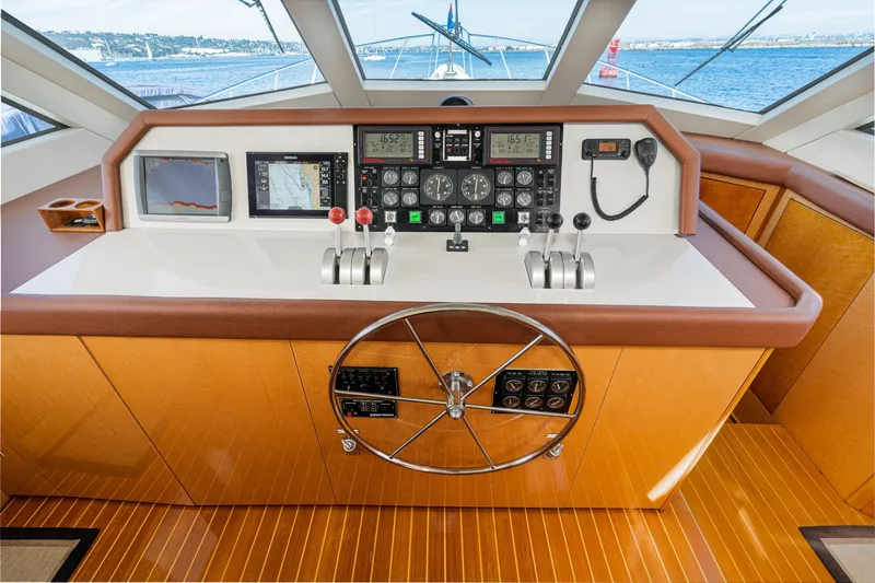 Slide: The Image of Helm of 1996 Hatteras 70 Sport Deck Motor Yacht with navigation instruments and steering wheel. - 46