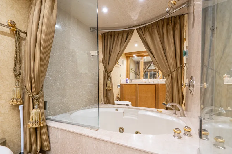 Slide: The Image of Luxurious bathroom with jacuzzi tub on 1996 Hatteras 70 Sport Deck Motor Yacht. - 56
