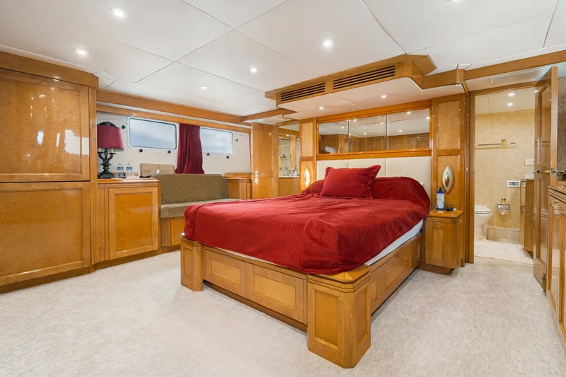 Slide: The Image of Luxurious bedroom in 1996 Hatteras 70 Sport Deck Motor Yacht with elegant wood finishes. - 52