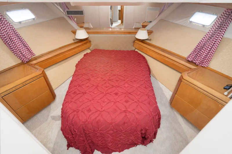 Slide: The Image of Luxurious bedroom interior of 1996 Hatteras 70 Sport Deck Motor Yacht with red bedding. - 58