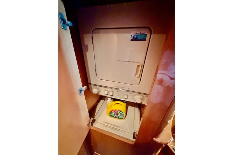Slide: The Image of Laundry area with washer-dryer unit on 1996 Hatteras 70 Sport Deck Motor Yacht. - 91