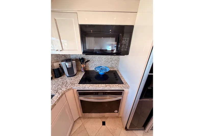 Slide: The Image of Modern kitchen in 1996 Hatteras 70 Sport Deck Motor Yacht with granite countertops. - 45