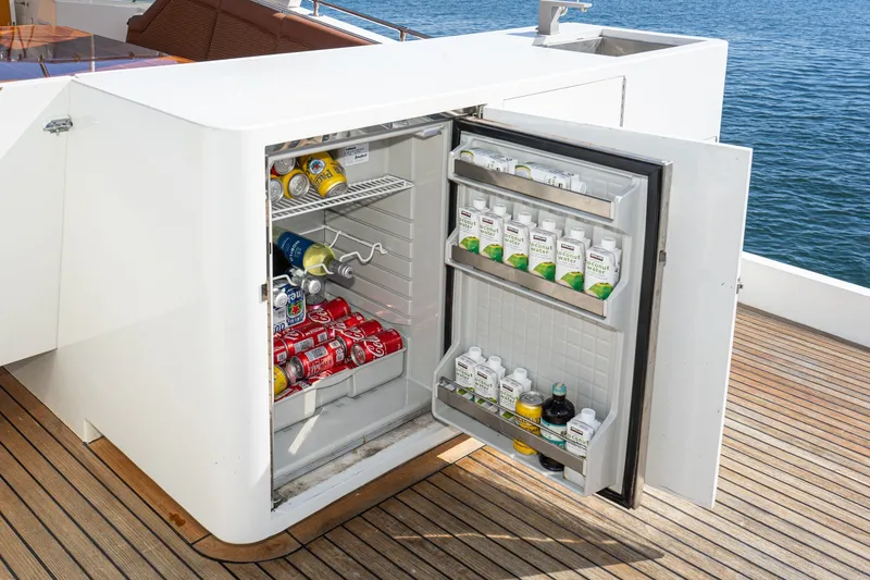 Slide: The Image of Outdoor fridge on 1996 Hatteras 70 Sport Deck Motor Yacht, stocked with beverages. - 14