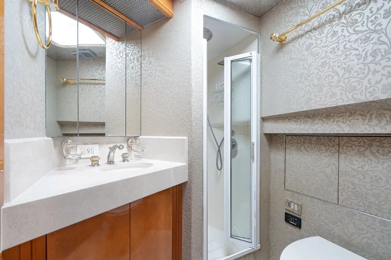 Slide: The Image of Luxurious bathroom in 1996 Hatteras 70 Sport Deck Motor Yacht with elegant fixtures and shower. - 62
