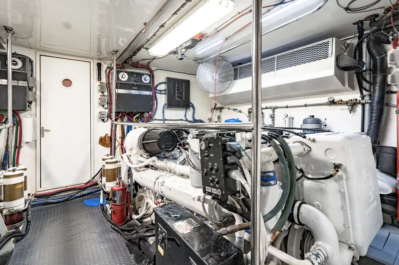 Slide: The Image of Engine room of a 1996 Hatteras 70 Sport Deck Motor Yacht, showcasing machinery and equipment. - 69